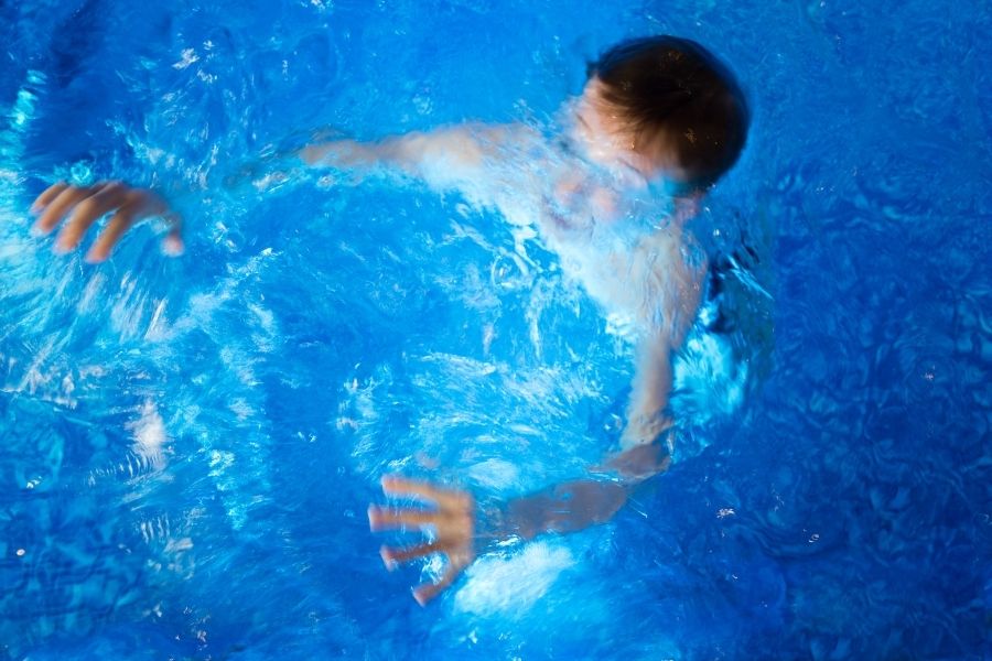 A young boy in the pool