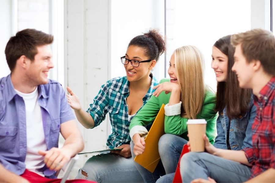 A group of people talking to each other happily