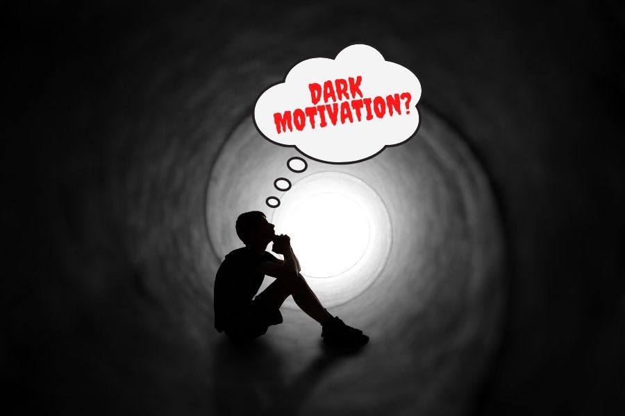 A ttenage boy sitting in a dark tunnel thinking about dark motivation