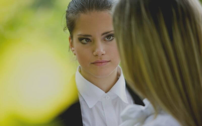 Two women are standing face to face