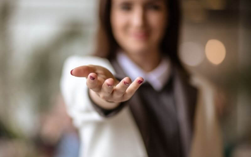 A woman holding out her hand to you