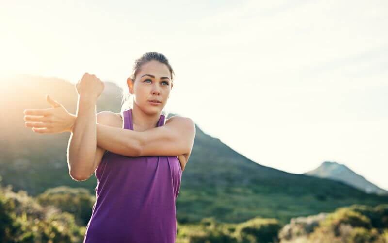 Cropped shot of an attractive young female athlete stretching before her morning run