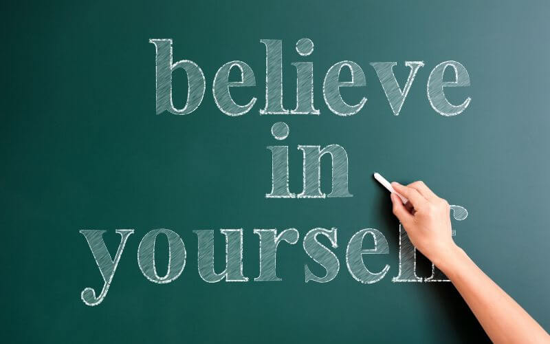 writing believe in yourself on blackboard