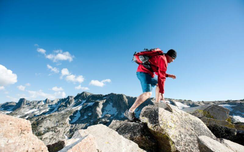 A man crossing a ridge on a mountain