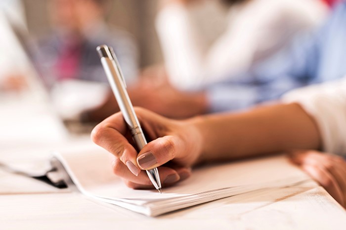 A lady writing on a letter