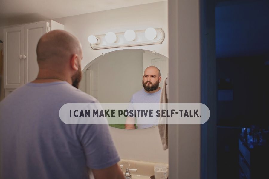 A man talking to himself at mirror saying an affirmation