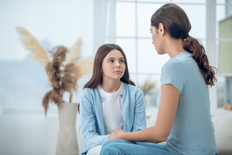 A mom is talking calmly to her daughter