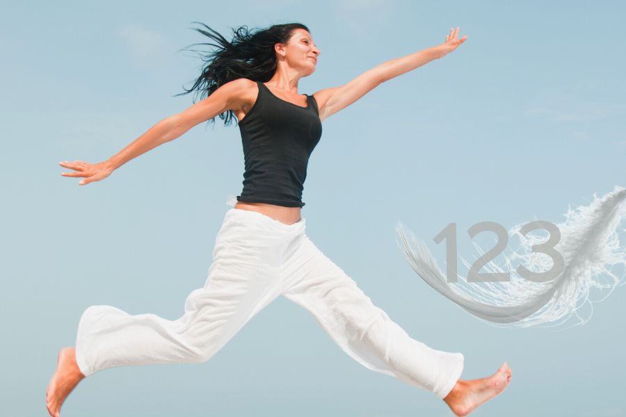 A lady is jumping and a feather with 123 number on it
