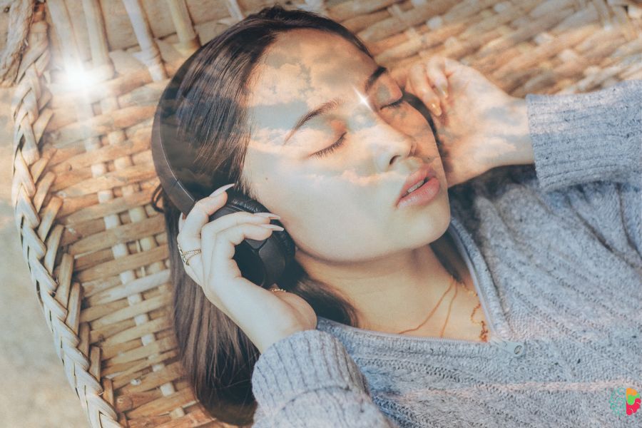 A lady is listening to music in headphone 