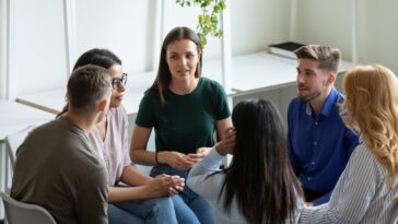 a group of people are talking about how they can improve their team mentality