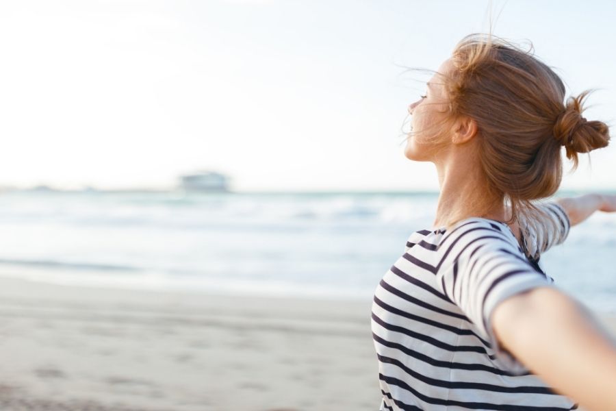 Happy and positive woman in the beach