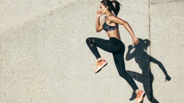 Healthy young female athlete doing fitness exercises.