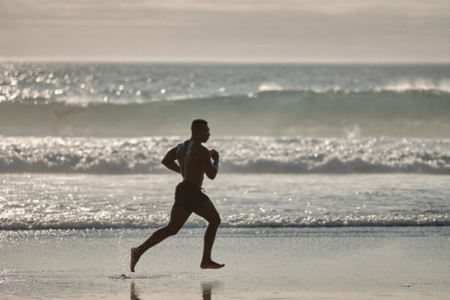 A man running at the beach representing you got this quotes