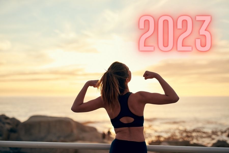 An atelic woman standing in sunrise representing healthy habits for 2023