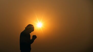 A human praying to the god in sunset