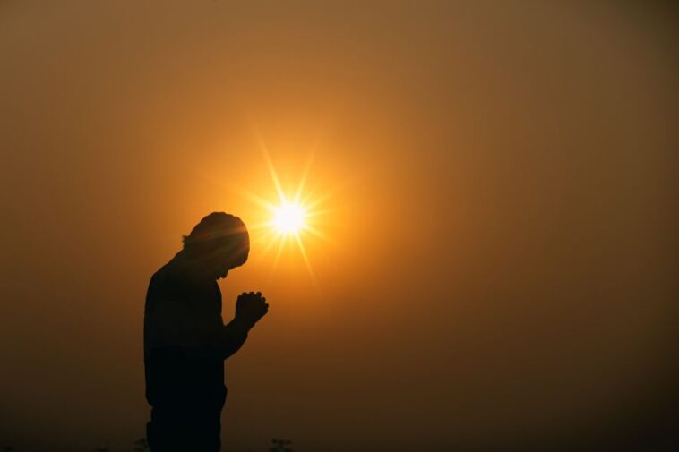 A human praying to the god in sunset