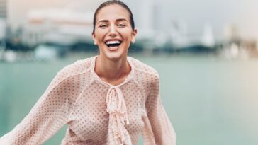 A woman laughing, representing funny affirmations